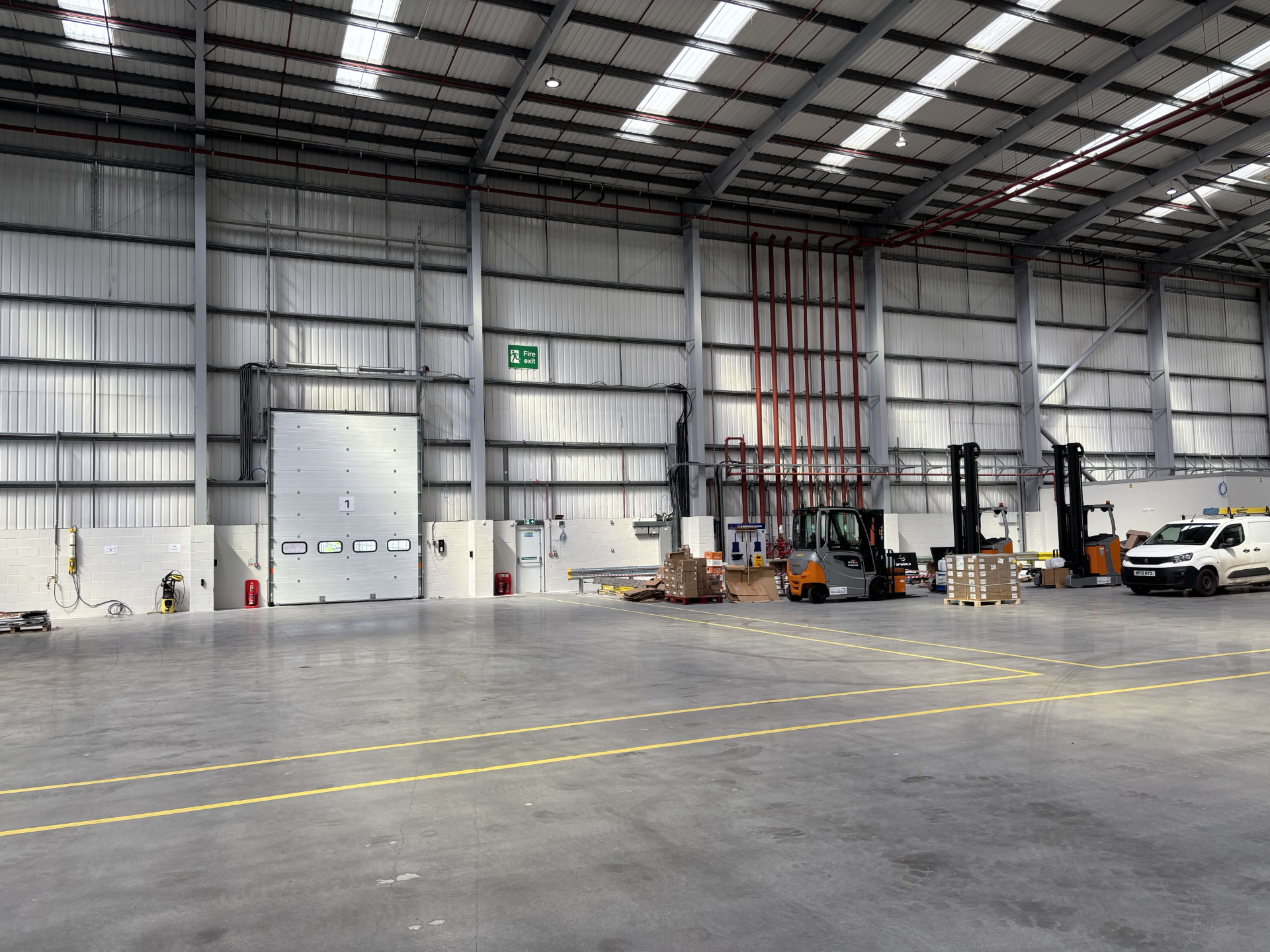 Interior of a commercial warehouse unit with sprinkler pipework